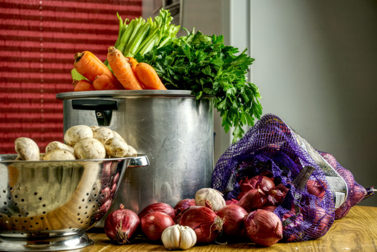 A photo showing the ingredients for the stock. From left to right, White button mushroom, Carrots, Celery, Parsely, Red Onion, Garlic